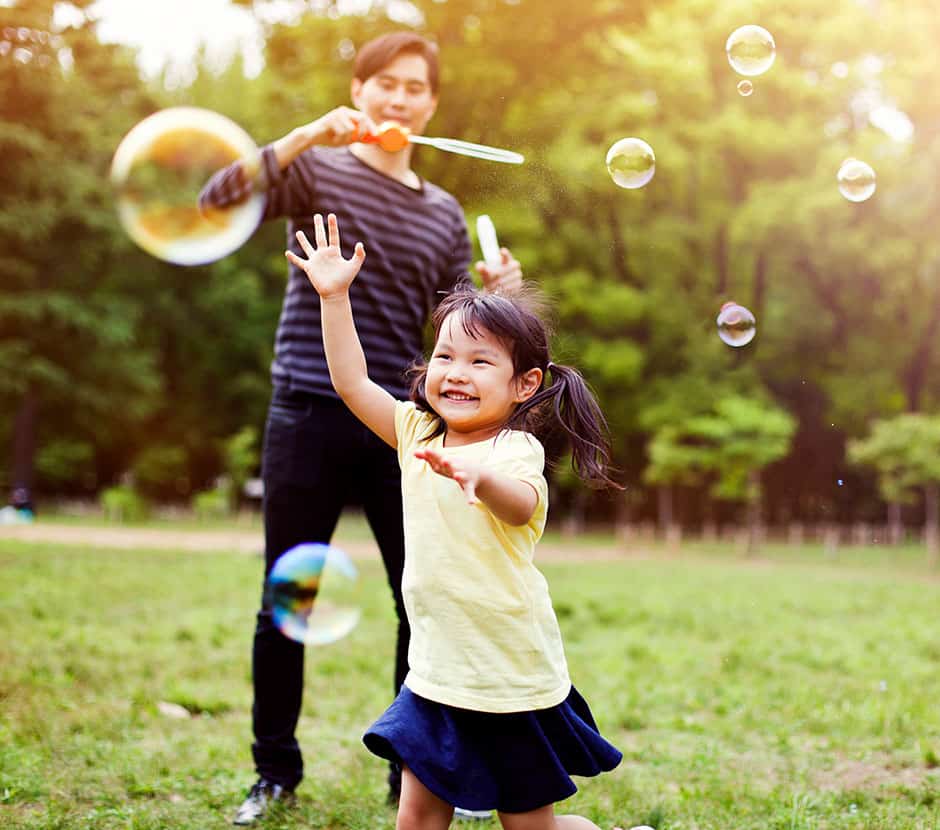 Little girl chasing bubbles