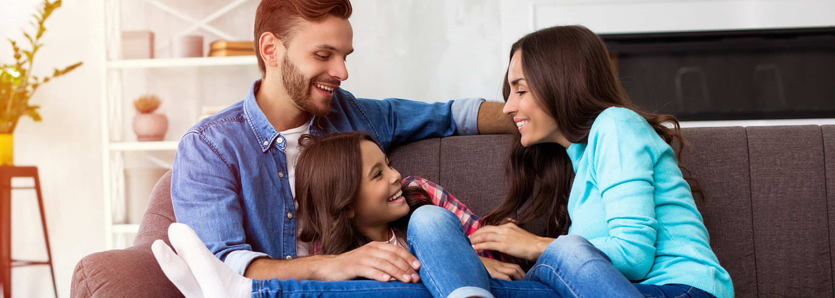 Family snuggling on the couch