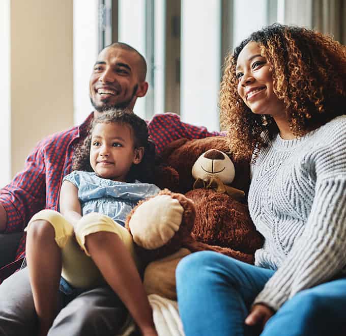 Family on the couch watching tv