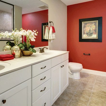 Bathroom with double sinks and red wall
