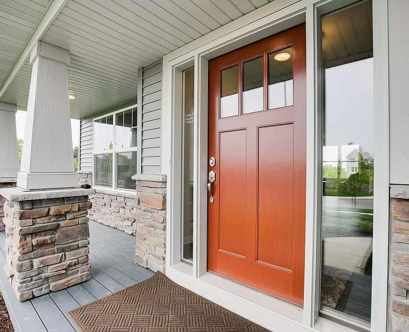 Warm brown front door, brick exterior