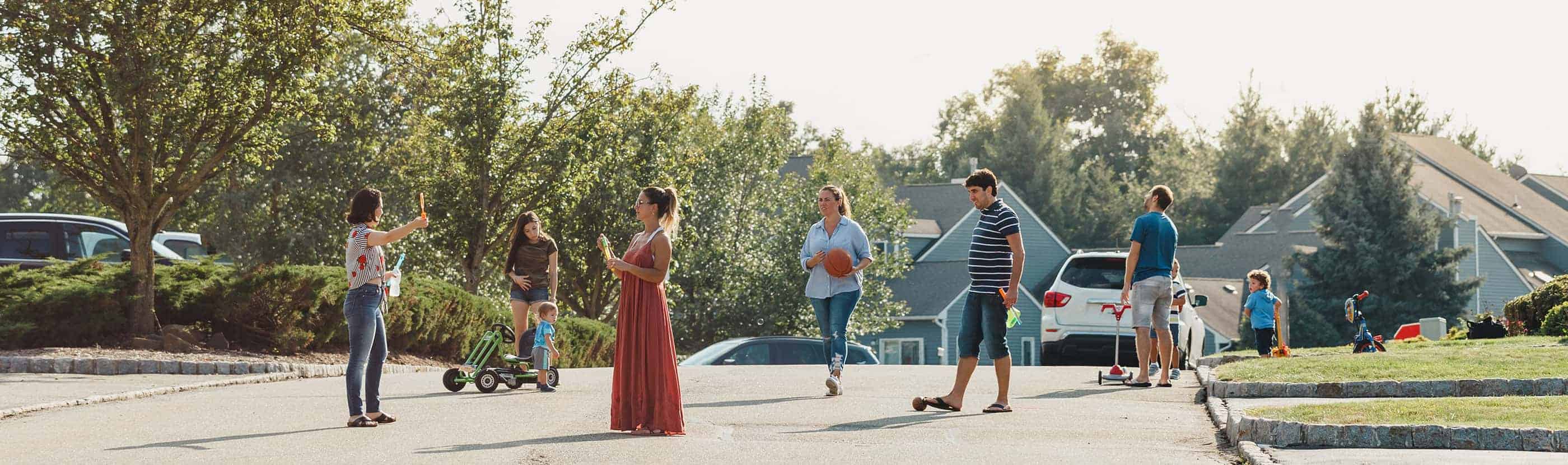 Neighbors gathering to chat and play in their street