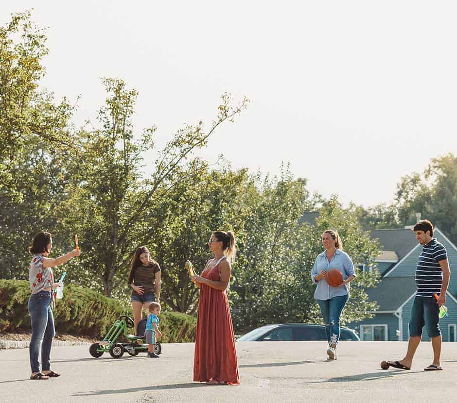 Neighbors gathering to chat and play in their street